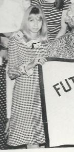 Yearbook photo of my dress while holding a Future Homemakers of America banner.